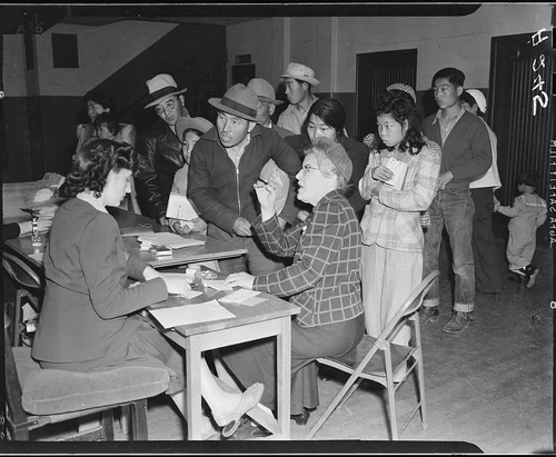 Salinas, California. The head of a family of Japanese descent checks in with clerks at this assembl . . . - NARA - 536189